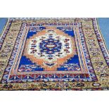 MODERN TURKEY WOOL PILE RUG of vibrant Persian design, the centre field with medallion within wide