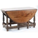 NINETEENTH CENTURY CARVED OAK GATELEG DINING TABLE, the top with 'D' shaped drop leaves and egg