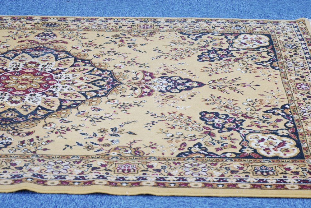 MACHINE MADE EASTERN BORDER CARPET, with large centre medallion with pendants on a gold and floral