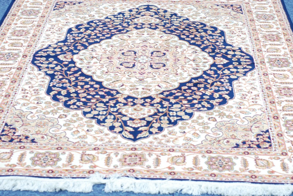 MODERN MACHINE MADE EASTERN RUG ON BLUE GROUND, 55" x 75"