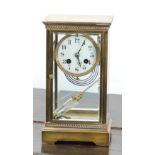 EARLY TWENTIETH CENTURY GILT BRASS FOUR GLASS MANTEL CLOCK, of typical form with 3 1/2" Arabic dial,