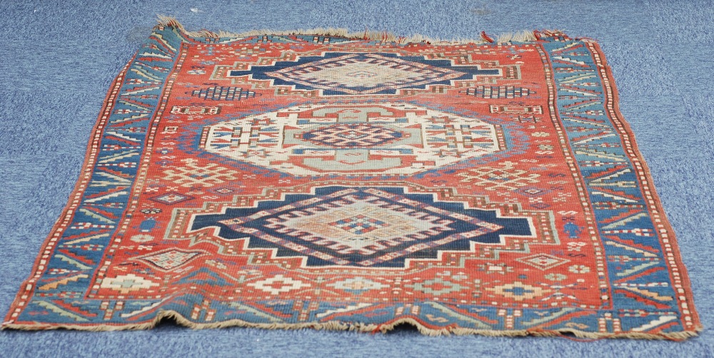 ANTIQUE N.W. PERSIA/CAUCASIAN WOLL PILE RUG, the brick red field with three medallions within a - Image 2 of 2