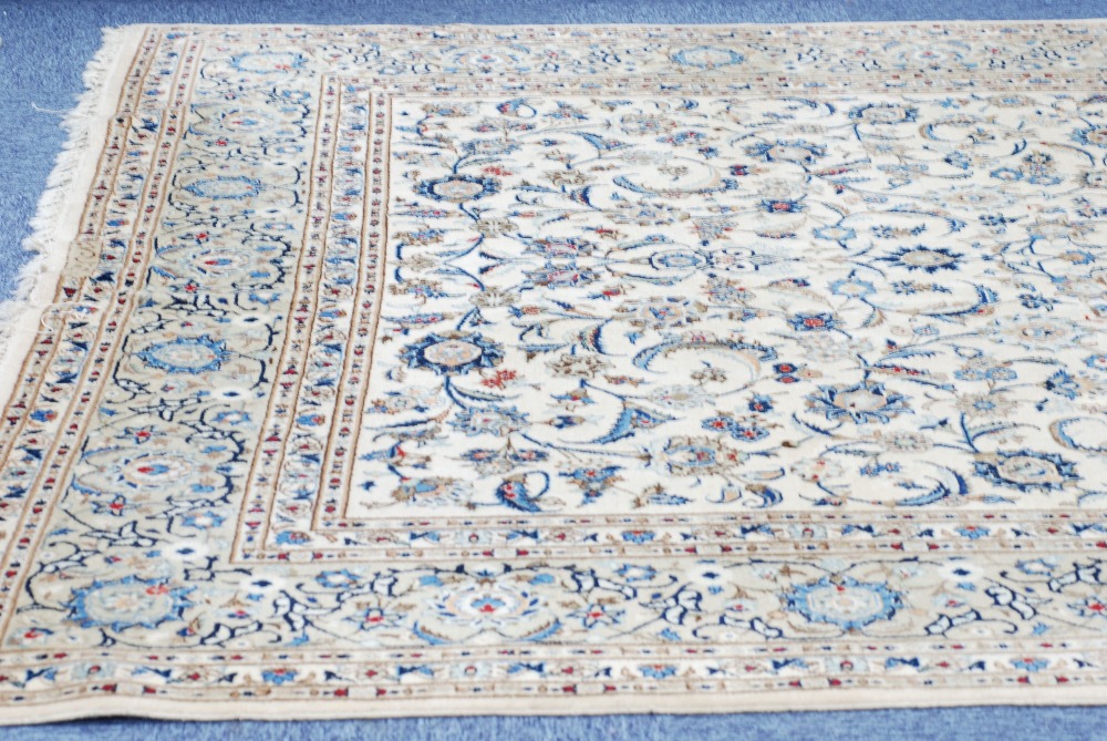 PERSIAN STYLE WOOL CARPET, with scrolling foliage containing palmettes and saz leaves worked in