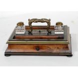 LATE REGENCY PERIOD ROSEWOOD BRASS INLAID AND EBONISED WOOD DESK STAND with opposing pen wells and