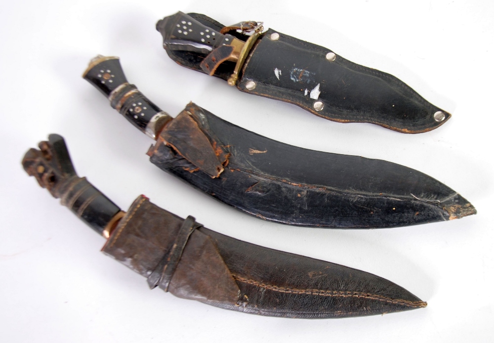 TWO SMALL NEPALESE/INDIAN KUKRIS of traditional design with horn handles and leather sheaths and a