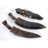 TWO SMALL NEPALESE/INDIAN KUKRIS of traditional design with horn handles and leather sheaths and a