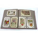 POSTCARD ALBUM CONTAINING 204 INTER WAR AND LATER POSTCARDS, including Birthday greetings, cats,