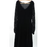 AN EARLY 1970's BLACK VELVET EVENING DRESS by 'Jinty's', London with transparent black nylon full