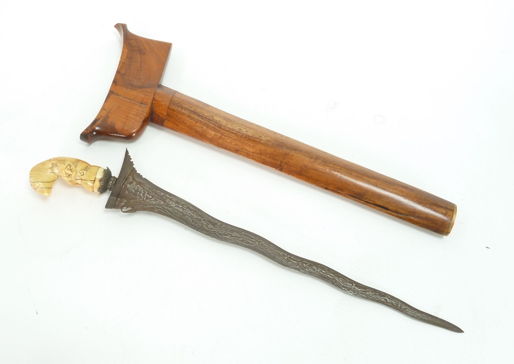 A MALAY KRIS in wooden sheath and good colour and with carved bone zoomorphic handle