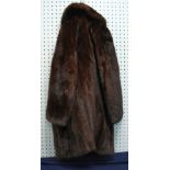 A DARK BROWN LADIES EVENING MINK COAT, WITH FOLD OVER COLLAR, FANCY BLACK BUTTONS WITH STONE DETAIL,