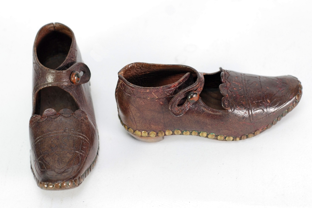 A PAIR OF EARLY TWENTIETH CENTURY LEATHER AND WOODEN SOLED CHILD'S CLOGS