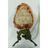 A CAMEO CARVED COWRIE SHELL OF THE THREE GRACES, on an associated metal stand as an electric table