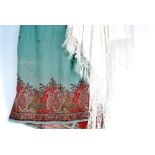 A LARGE PRINTED FABRIC 'PAISLEY' SHAWL, plain green with broad crimson borders with elaborate Bohteh