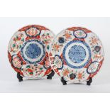 TWO NEAR MATCHING JAPANESE IMARI CIRCULAR PLAQUES, decorated with central blue floral motif,