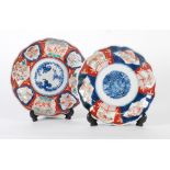 TWO JAPANESE IMARI PLAQUES WITH BLUE FLORAL CENTRES, scalloped rims, 9" (22.8cm) diameter and