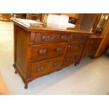 A ART NOUVEAU MAHOGANY SIDEBOARD, RAISED PIERCED BACK OVER SIX GRADUATED SHORT DRAWERS, WITH
