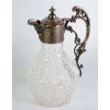 CUT GLASS CLARET JUG, with electroplated mounts, of slightly compressed form with mask spout,