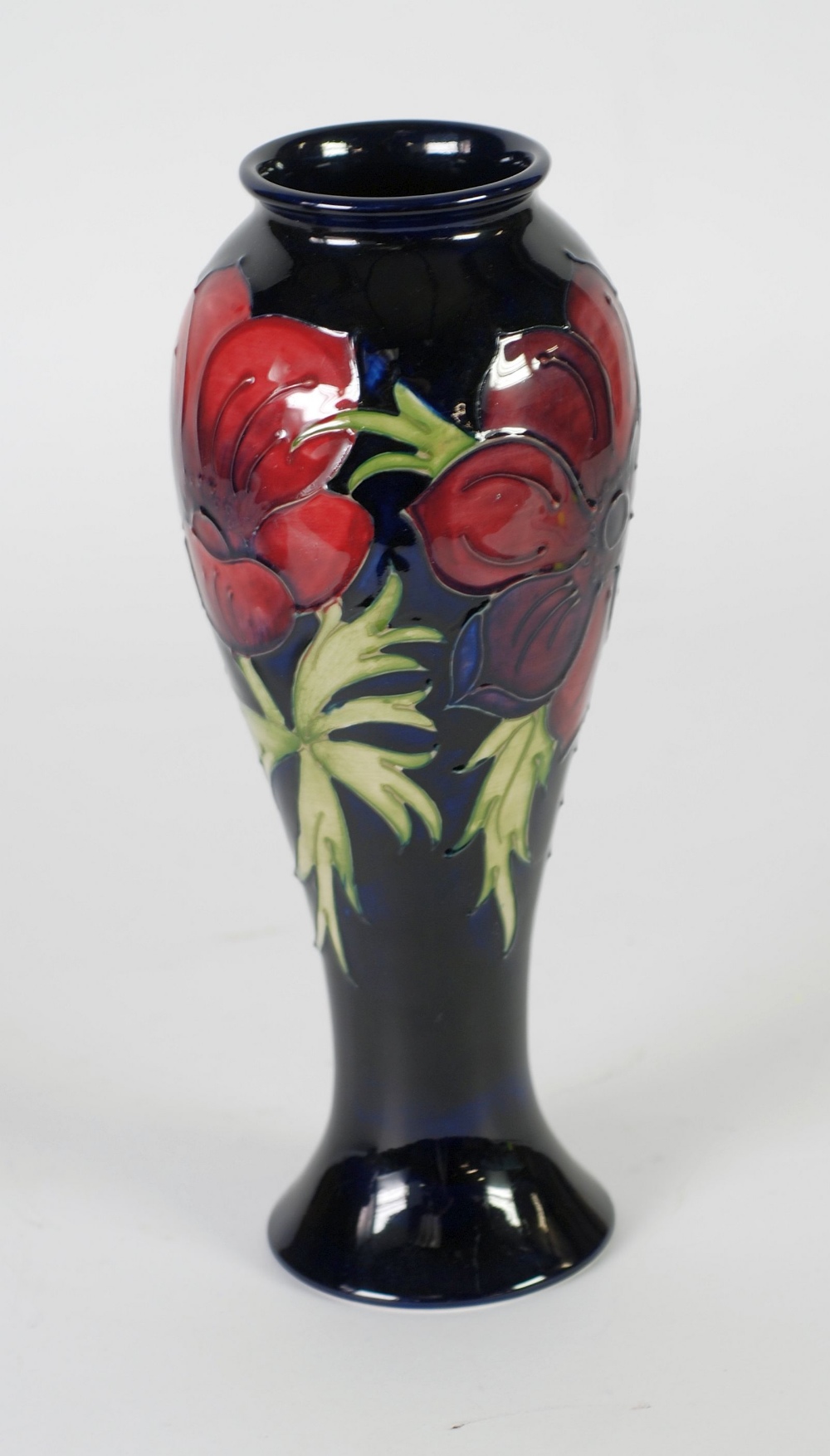WALTER MOORCROFT ANEMONE PATTERN TUBE LINED POTTERY VASE, of slender ovoid form with lipped rim,