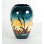 A WALTER MOORCROFT TUBE LINED POTTERY OVOID VASE, decorated with bull-rushes at sunset, monogram