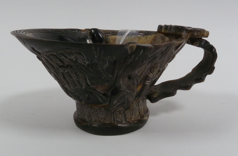 CHINESE CARVED COW HORN LIBATION CUP, of typical form, decorated with figures and foliage, 2 3/4" (