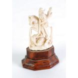 EARLY TWENTIETH CENTURY CARVED IVORY GROUP OF ST. GEORGE AND THE DRAGON, 2 1/42 (5.7cm) high, on