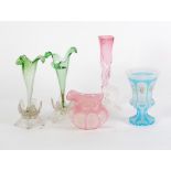 PAIR OF GREEN GLASS TRUMPET VASES, of organic form with clear pressed petal shaped pedestal bases, 7