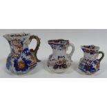 THREE NINETEENTH CENTURY MASON'S IRONSTONE CHINA GRADUATED JUGS, octagonal with Imari painted floral