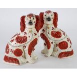 PAIR OF VICTORIAN STAFFORDSHIRE POTTERY MANTLE DOGS, each of typical form with one front leg