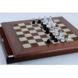 SWAROVSKI CUT GLASS CHESS SET, STYLISED FIGURES IN CLEAR AND BLACK, housed in a fitted drawer with