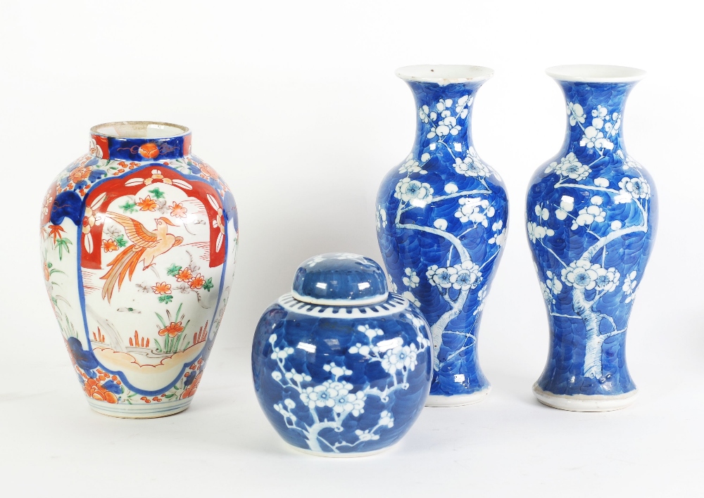 A PAIR OF CHINESE BLUE AND WHITE PRUNUS BLOSSOM DECORATED INVERTED BALUSTER SHAPE VASES, slender