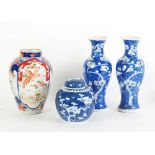 A PAIR OF CHINESE BLUE AND WHITE PRUNUS BLOSSOM DECORATED INVERTED BALUSTER SHAPE VASES, slender