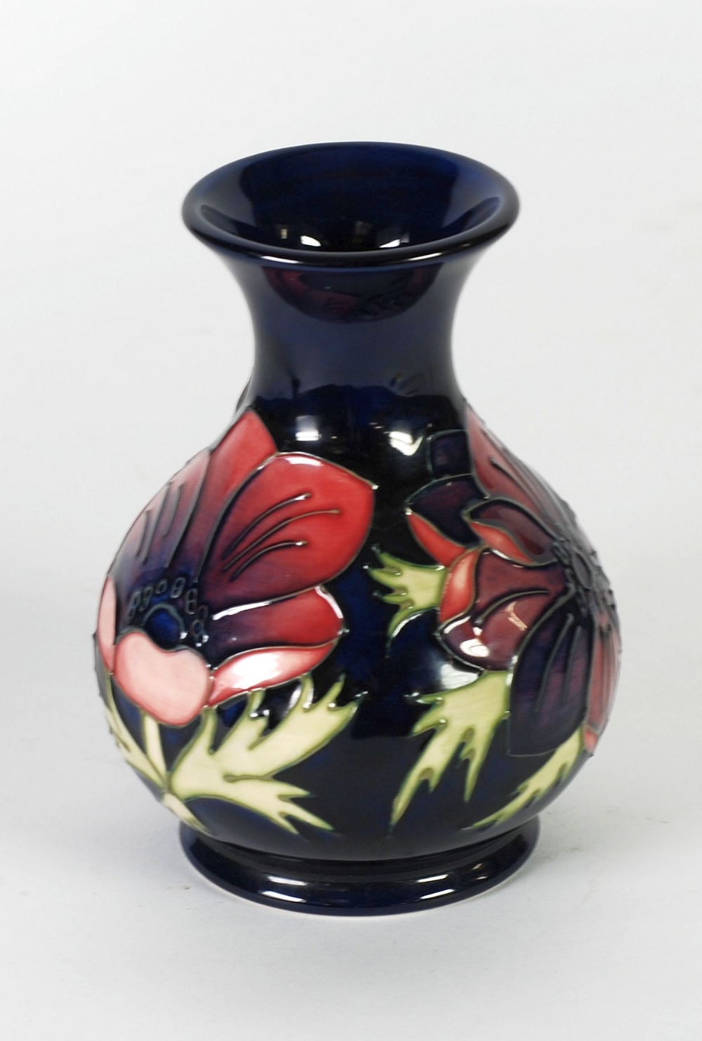 WALTER MOORCROFT ANEMONE PATTERN TUBE LINED POTTERY VASE, of footed baluster form with waisted neck,