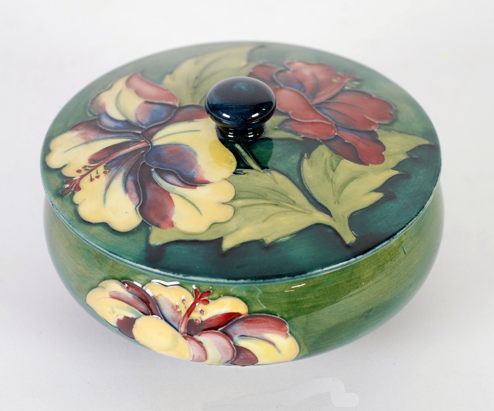 WALTER MOORCROFT HIBISCUS PATTERN TUBE LINED POWDER BOWL AND COVER, typical form, decorated in tones