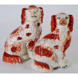 THREE VARIOUS VICTORIAN STAFFORDSHIRE POTTERY MANTLE DOGS, each of typical form with burnt orange