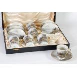 CASED SET OF SIX EARLY TWENTIETH CENTURY JAPANESE PEACOCK CHINA WARE TEA CUPS AND SAUCERS, hand