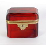 TWENTIETH CENTURY RUBY GLASS AND GILT METAL MOUNTED CASKET of canted oblong form, 4" (10.2cm)