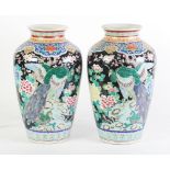 A PAIR OF EARLY TWENTIETH CENTURY CHINESE FAMILLE NOIRE ENAMELLED PORCELAIN VASES, each of ovoid