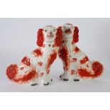 PAIR OF VICTORIAN STAFFORDHSHIRE POTTERY MANTLE DOGS, typically modelled and with burnt orange