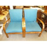 A PAIR OF 1930's WOODEN FRAMED FIRESIDE ARMCHAIRS, THE BACKS AND SEATS COVERED IN BLUE PATTERNED