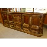 TWENTIETH CENTURY CONTINENTAL WALNUTWOOD SIDEBOARD, WITH BROADLY CANTED FORECORNERS, CAVETTO
