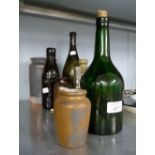 FOUR OLD COLOURED GLASS BOTTLES, A SMALL PLAIN GLASS BOTTLE AND FOUR BROWN WARE JARS