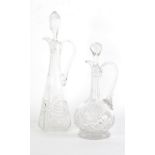 TWO CUT GLASS CLARET JUGS, with stoppers, one of footed baluster form with tall, slender neck,