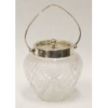 CUT GLASS OVULAR BISCUIT BARREL with silver neck, swing handle and silver removable lid with ball