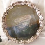 SILVER SALVER, CHIPPENDALE BORDER, raised on three scroll feet, with presentation inscription,