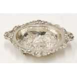 EDWARDIAN SILVER OVAL SWEETMEAT DISH, repousse with flowers, the shaped flat border embossed with