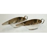 PAIR OF PLANISHED SILVER SMALL OVAL SAUCE BOATS, with open lip fronts, 'C' scroll handles, on reeded