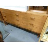 A PAIR OF 1970s MAHOGANY BEDSIDE CUPBOARDS EACH WITH A DRAWER ABOVE, ON TAPERING LEGS AND A TEAK