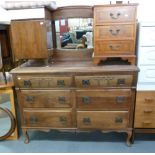 AN EARLY 20TH CENTURY ARTS & CRAFTS CARVED WALNUT SIDEBOARD, THE RAISED BACK HAVING AN OVAL,