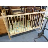 A CHILD'S BEECH WOOD DROP-SIDE COT