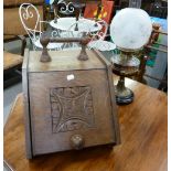 VICTORIAN CARVED OAK SLOPE FRONT COAL RECEIVER AND A LATE VICTORIAN TABLE OIL LAMP WITH GLASS